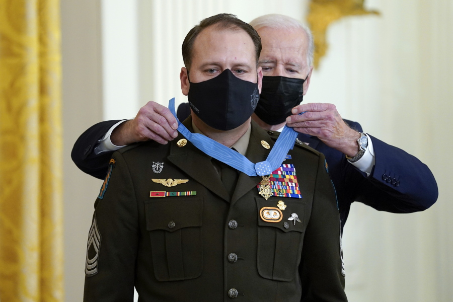 President Joe Biden presents the Medal of Honor to Army Master Sgt. Earl Plumlee for his actions in Afghanistan on Aug. 28, 2013, during an event in the East Room of the White House, Thursday, Dec. 16, 2021, in Washington.