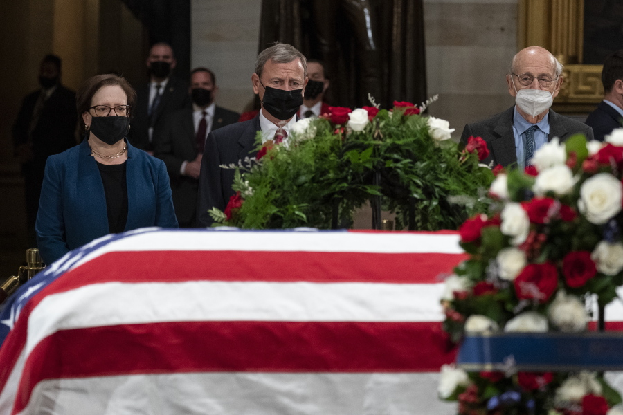 Justice Elena Kagan, left, Chief Justice John Roberts, and Justice Stephen Breyer pay their respects as the flag-draped casket of former Sen. Bob Dole, R-Kan., lies in state in the U.S. Capitol on Thursday, Dec. 9, 2021, in Washington.