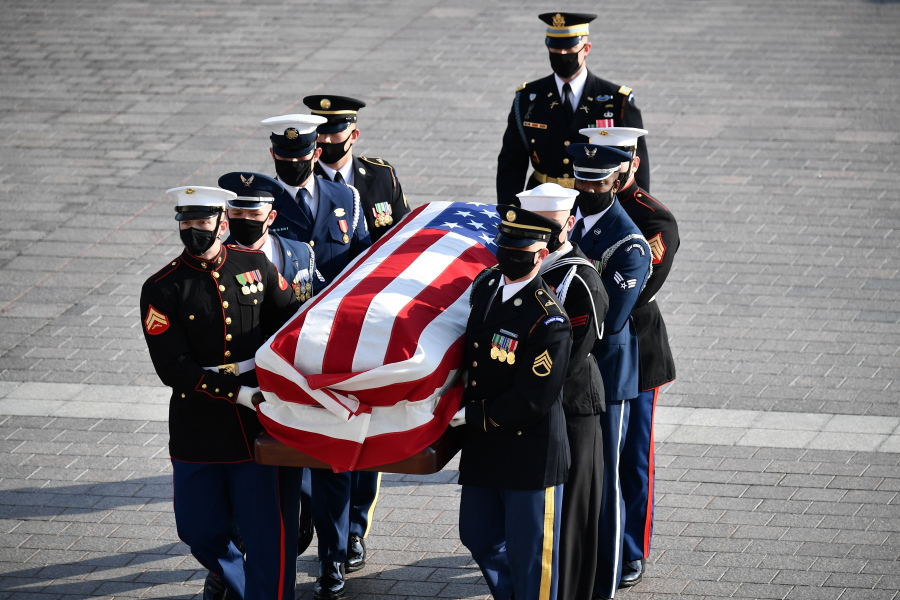 A joint forces military bearer team carries the casket of former Sen. Bob Dole up the stairs as he arrives at the U.S. Capitol in Washington, to lie in state, Thursday, Dec. 9, 2021.