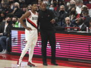 Portland Trail Blazers coach Chauncey Billups, right, talks to guard Dennis Smith Jr., left, during the first half of the team's NBA basketball game against the Boston Celtics in Portland, Ore., Saturday, Dec. 4, 2021.
