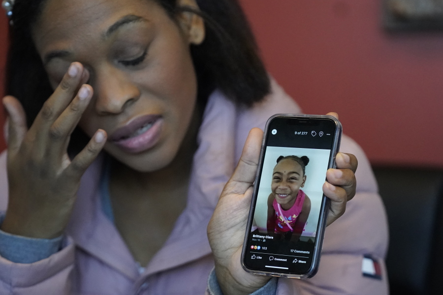 Brittany Tichenor-Cox, holds a photo of her daughter, Isabella "Izzy" Tichenor, during an interview Monday, Nov. 29, 2021, in Draper, Utah. Tichenor-Cox said her 10-year-old daughter died by suicide after she was harassed for being Black and autistic at school. She is speaking out about the school not doing enough to stop the bullying.