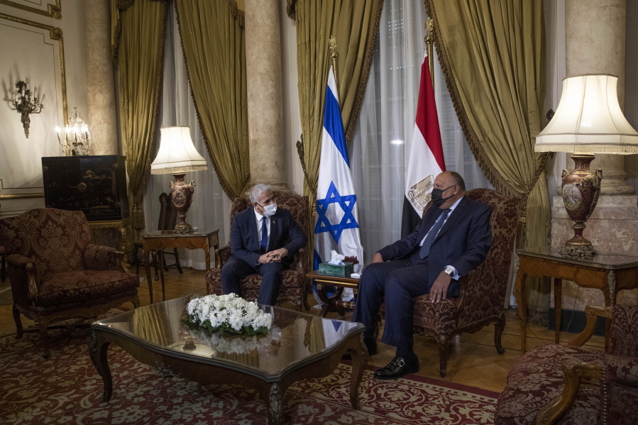 Israeli Foreign Minister Yair Lapid, left, meets with Egyptian Foreign Minister Sameh Shoukry at the Tahrir Palace in Cairo, Egypt, Thursday, Dec. 9, 2021.