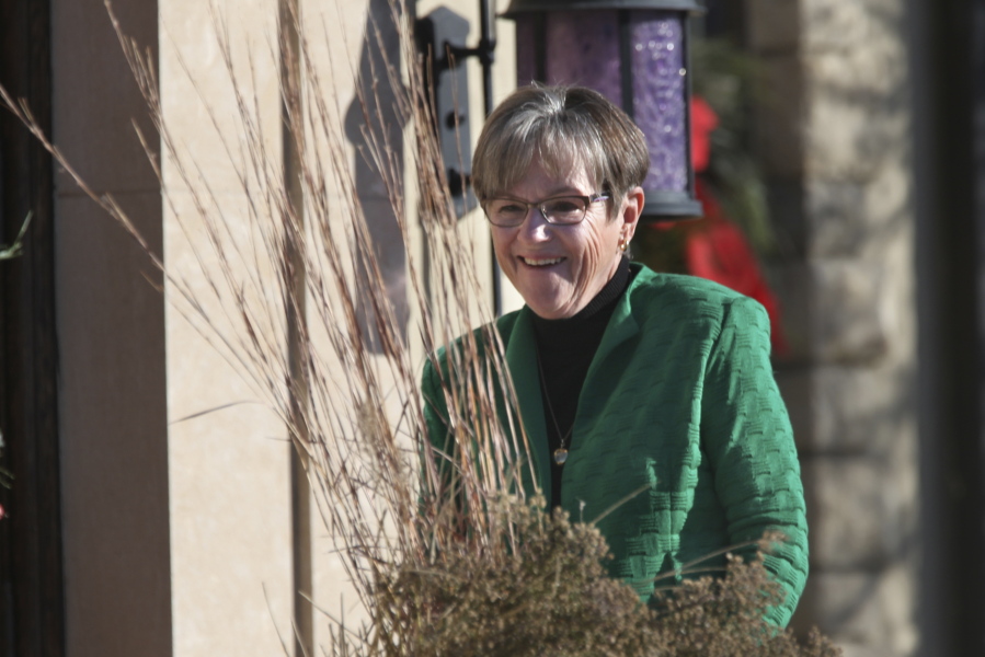FILE- Kansas Gov. Laura Kelly Kansas Gov. Laura Kelly walks back to the front door of the governor's official residence on Nov. 23, 2021 in Topeka, Kan.