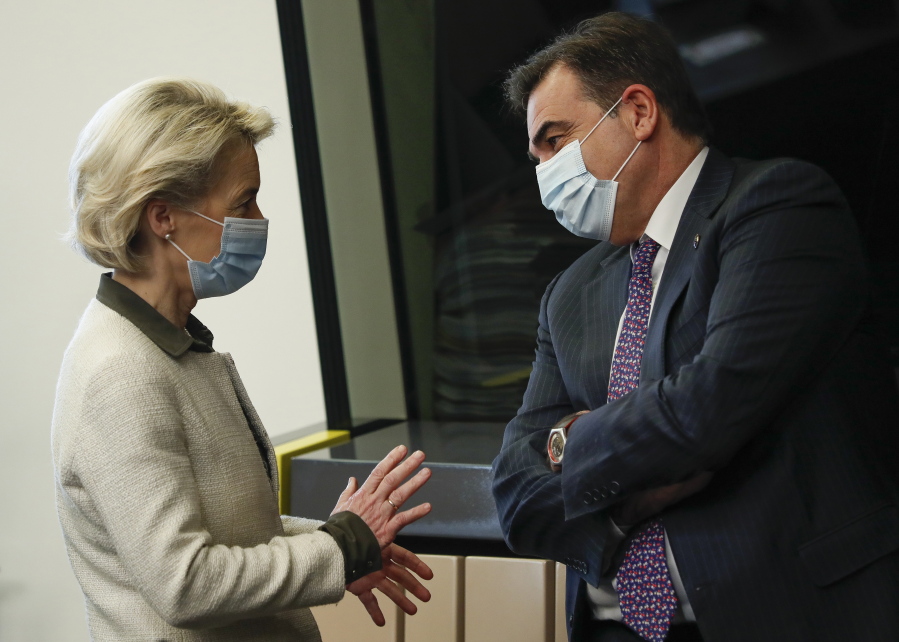 European Commission President Ursula von der Leyen speaks with European Way of Life Commissioner Margaritis Chinas, right, prior to the meeting of College of Commissioners, in Strasbourg, France, Tuesday, Dec. 14 2021. The College will discuss on a comprehensive package on energy and climate action and will also adopt a proposal for a revision of the Schengen Borders Code.