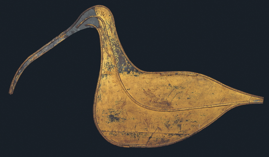 This image provided by the American Folk Art Museum shows the Hudsonian Curlew weather vane. The museum's curator, Emelie Gevalt, said one of her favorite pieces in the exhibit is the museum's own "Hudsonian Curlew." The 1874 piece is large, nearly 7 feet tall and 4 feet wide. A relatively simple design, it depicts the body and distinctive curved beak of the shorebird in gold-leafed sheet metal, and once sat atop the Curlew Bay sportsmen's club in Seaville, New Jersey.