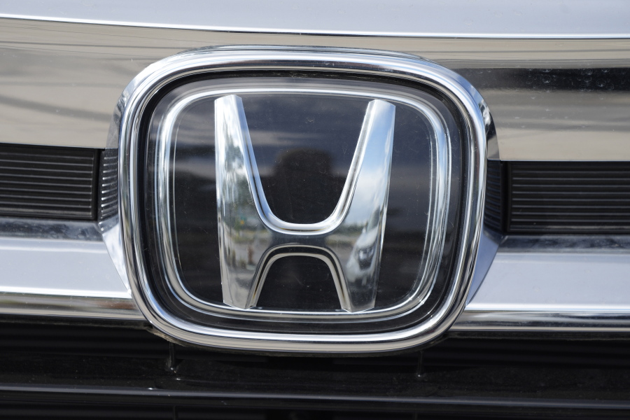 The company logo shinesoff the grille of an unsold 2021 Pilot sports-utility vehicle outside a Honda dealership Sunday, Sept. 12, 2021, in Highlands Ranch, Colo. Honda is recalling nearly 723,000 SUVs and pickup trucks, Friday, Dec. 3,  because the hoods can open while the vehicles are moving. The recall covers certain 2019 Passports, 2016 through 2019 Pilots and 2017 through 2020 Ridgeline pickups.