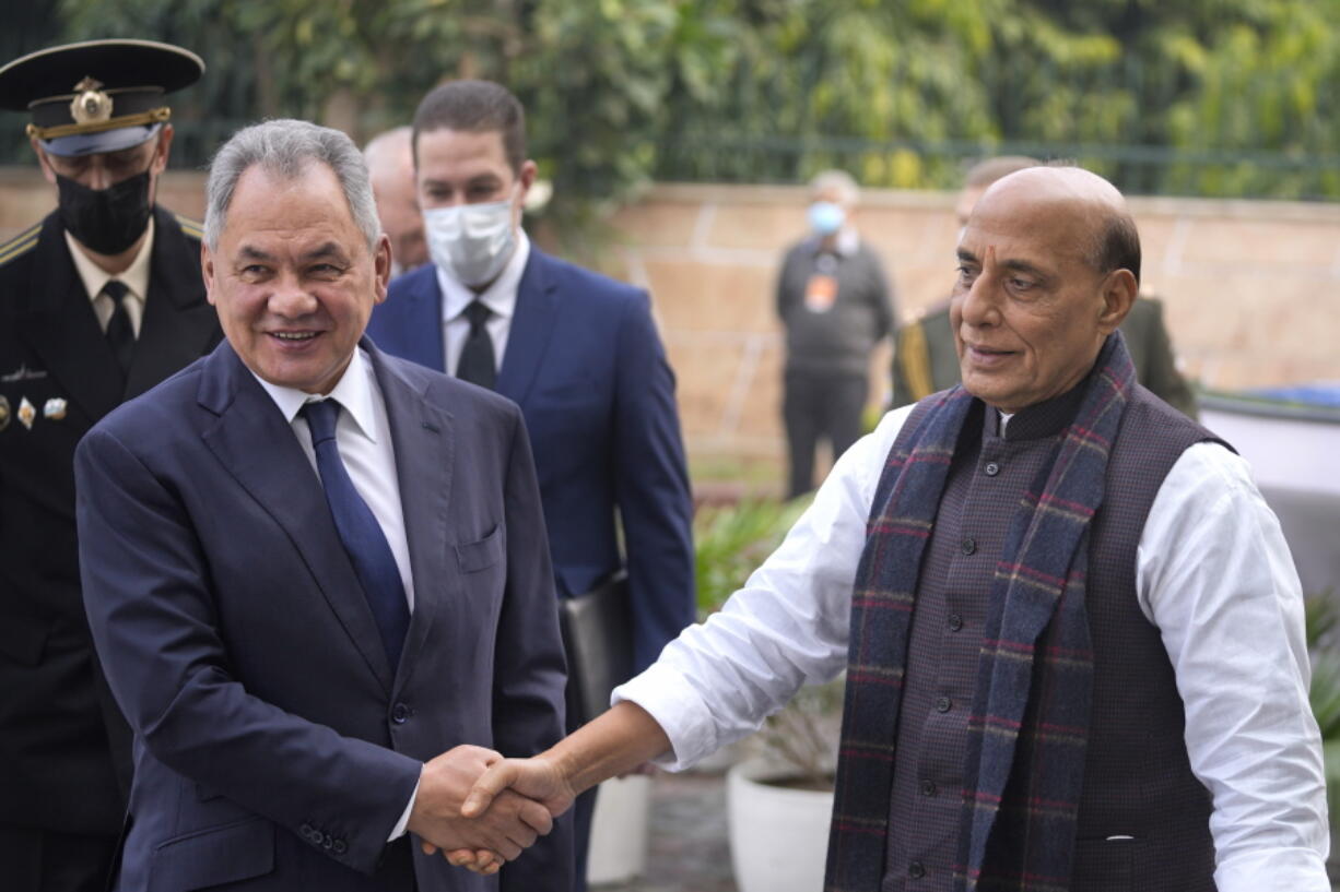 Indian Defence Minister Rajnath Singh, right, shakes hand with his Russian counterpart Sergey Shoygu in New Delhi, India, Monday, Dec. 6, 2021. Indian Prime Minister Narendra Modi meets with Russian President Vladimir Putin on Monday to discuss defense and trade relations as India attempts to balance its ties with the United States.