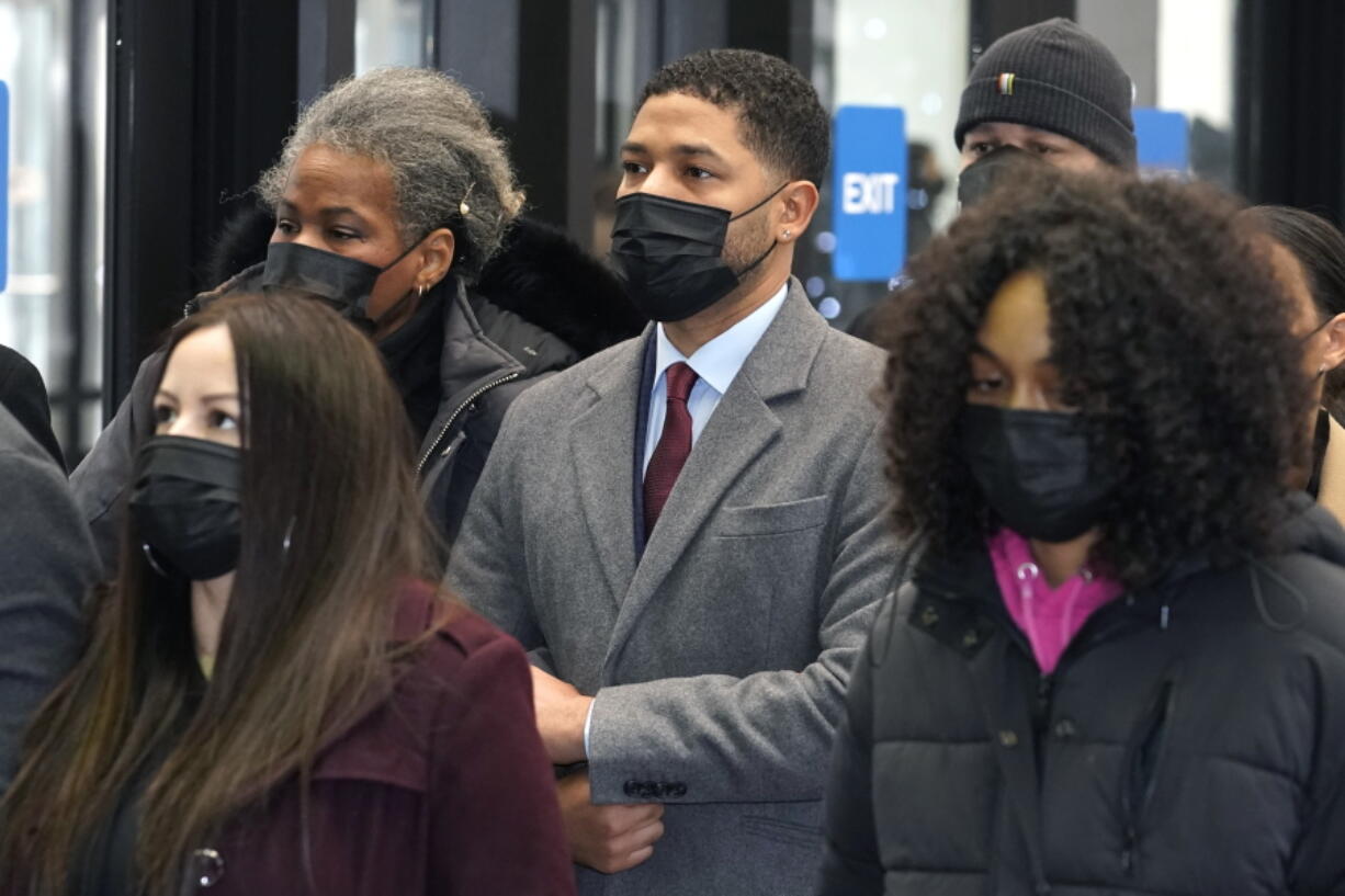 Actor Jussie Smollett, center, arrives with his mother Janet, left, and other family members at the Leighton Criminal Courthouse for day three of his trial in Chicago on Wednesday, Dec. 1, 2021. Smollett is accused of lying to police when he reported he was the victim of a racist, anti-gay attack in downtown Chicago nearly three years ago.