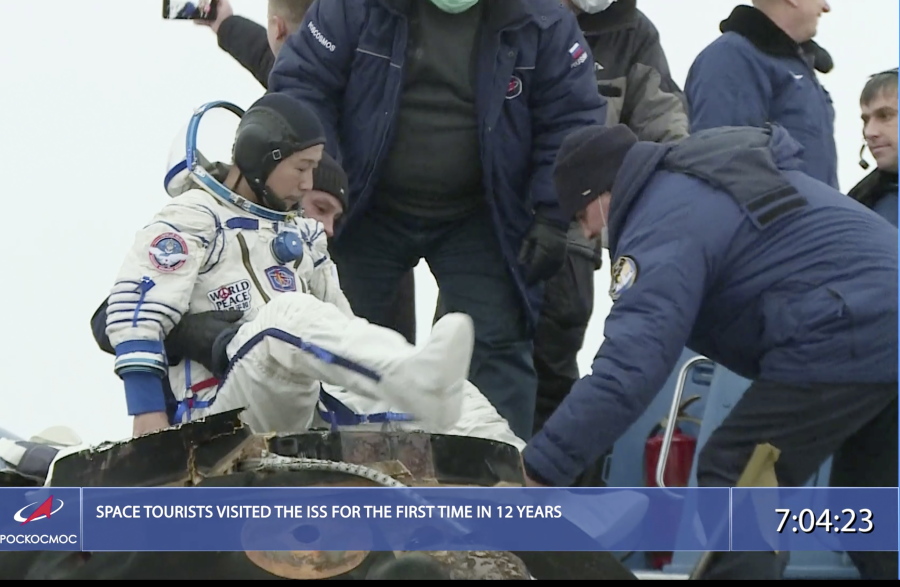 In this photo taken from video footage released by the Roscosmos Space Agency, Russian space agency rescue team help spaceflight participant Yusaku Maezawa to get from the capsule shortly after the landing of the Russian Soyuz MS-20 space capsule about 150 km ( 80 miles) south-east of the Kazakh town of Zhezkazgan, Kazakhstan, Monday, Dec. 20, 2021. The Japanese billionaire, his producer and a Russian cosmonaut safely returned to Earth on Monday after spending 12 days on the International Space Station.