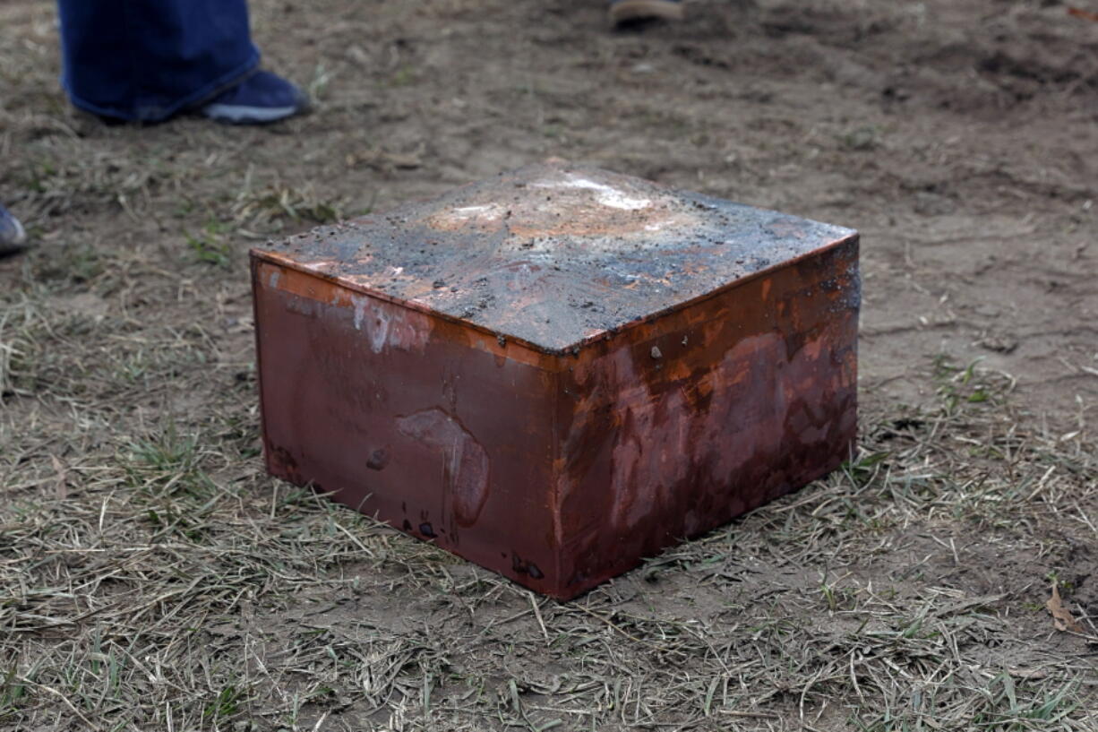 Workers recover a box believed to be the 1887 time capsule that was put under Confederate Gen. Robert E. Lee's statue pedestal in Richmond, Va., Monday, Dec. 27, 2021. Crews wrapping up the removal Monday of the giant pedestal that once held a statue of Confederate Gen. Lee found what appeared to be a second and long-sought-after time capsule, Virginia Gov. Ralph Northam said.