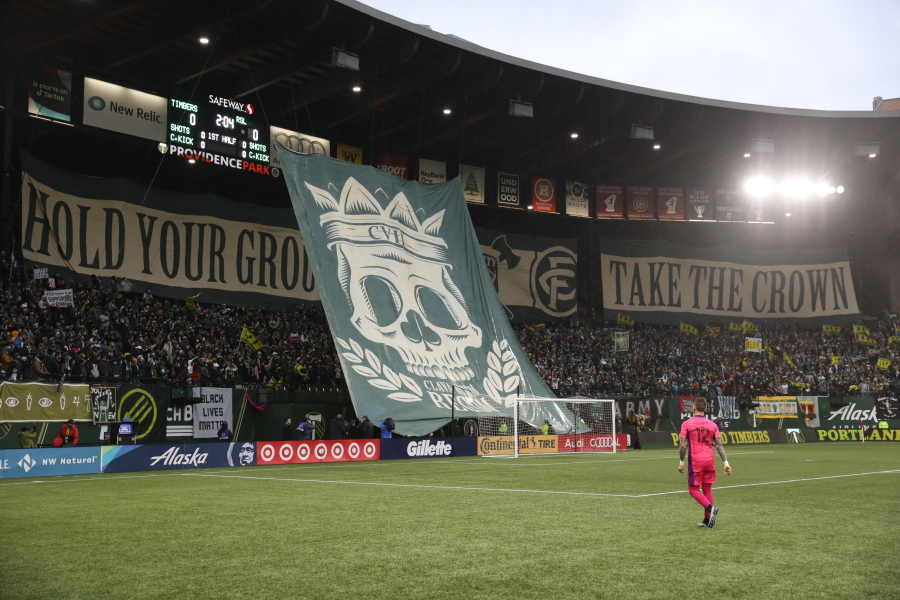 Portland Timbers goalkeeper Steve Clark (12) walks onto the pitch as a tifo is displayed before the MLS soccer Western Conference final between the Timbers and Real Salt Lake on Saturday, Dec. 4, 2021, in Portland, Ore.