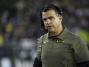 FILE -O regon head coach Mario Cristobal watches the action during the third quarter of an NCAA college football game Saturday, Nov. 13, 2021, in Eugene, Ore. Manny Diaz was fired as Miami's football coach Monday, Dec. 6, 2021, after a 7-5 regular season and with the school in deep negotiations to bring Oregon coach Mario Cristobal back to his alma mater to take over.