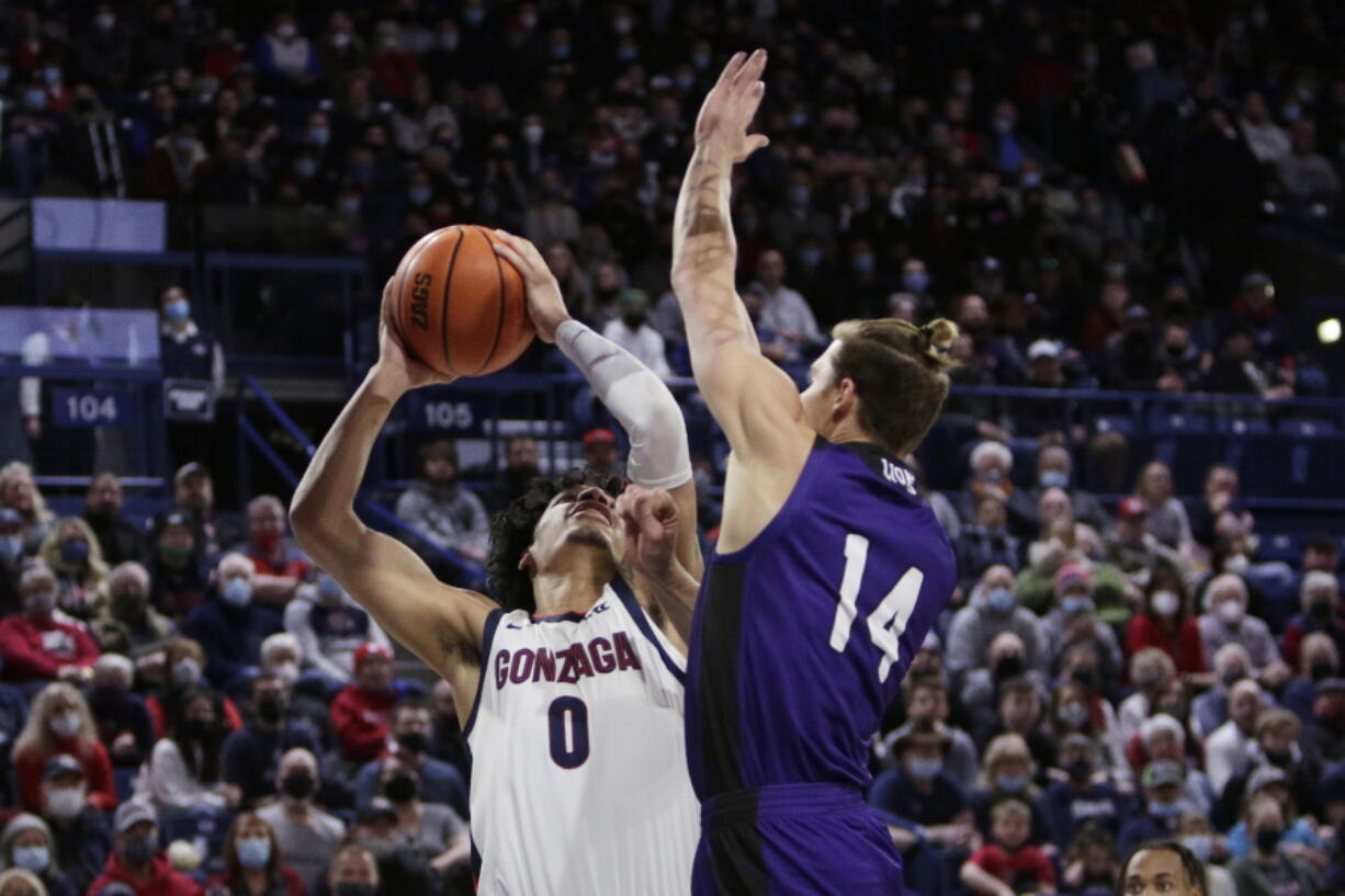Gonzaga guard Julian Strawther (0) shoots while pressured by North Alabama forward Payton Youngblood (14) during the first half of an NCAA college basketball game, Tuesday, Dec. 28, 2021, in Spokane, Wash.