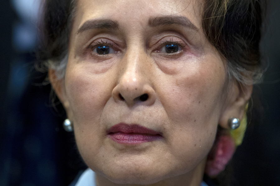 FILE - Myanmar's leader Aung San Suu Kyi waits to address judges of the International Court of Justice on the second day of three days of hearings in The Hague, Netherlands, on Dec. 11, 2019. A human rights group has called on the International Criminal Court to open an investigation into the crackdown on dissent by Myanmar's military rulers, alleging that the leader of the February coup that ousted civilian leader Aung San Suu Kyi is responsible for widespread and systematic torture.