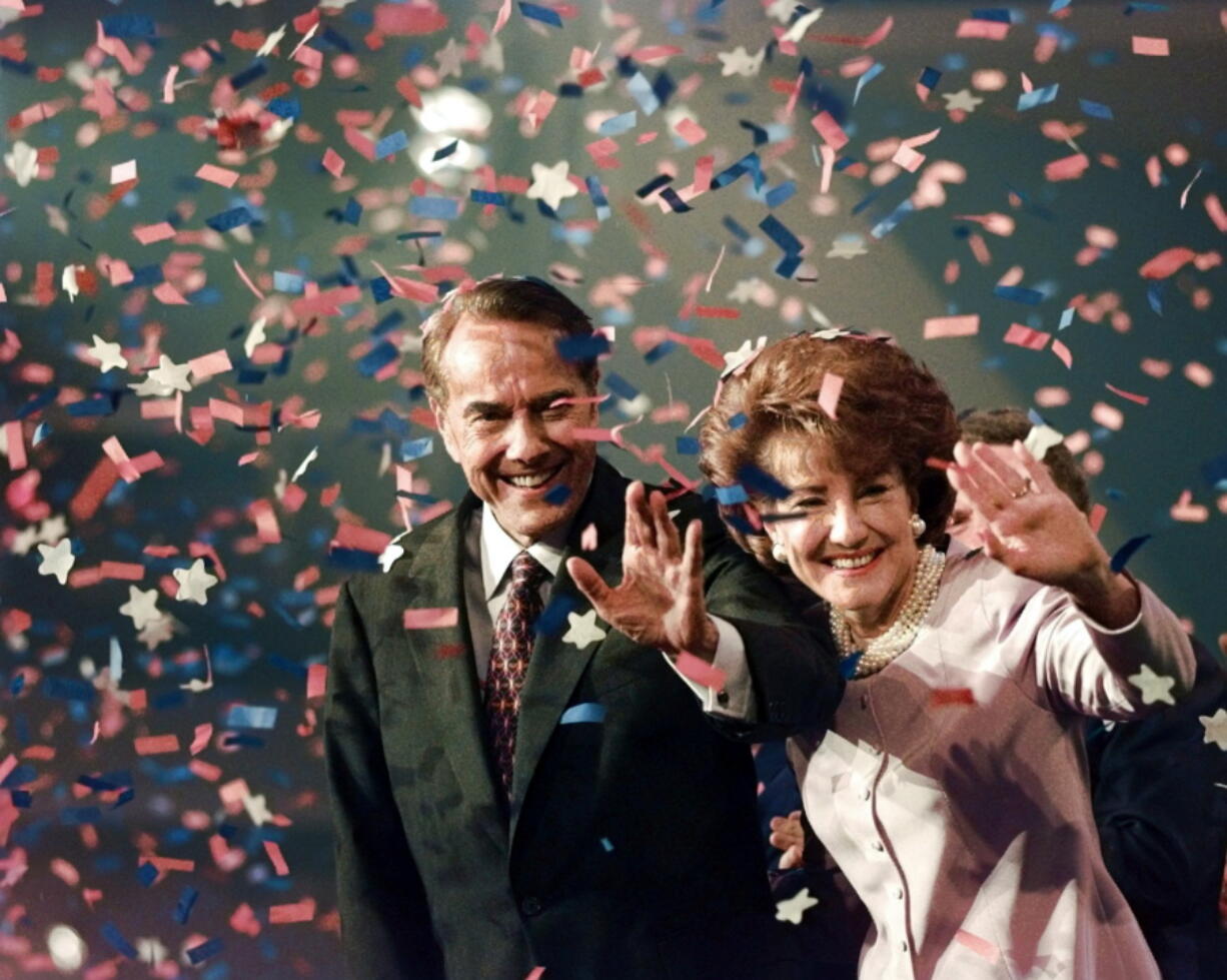 FILE - Bob Dole and his wife Elizabeth wave from the podium on the floor of the Republican National Convention in San Diego, as confetti falls after Dole accepted the Republican presidential nomination. Bob Dole, who overcame disabling war wounds to become a sharp-tongued Senate leader from Kansas, a Republican presidential candidate and then a symbol and celebrant of his dwindling generation of World War II veterans, has died. He was 98. His wife, Elizabeth Dole, posted the announcement Sunday on Twitter (AP Photo/J.