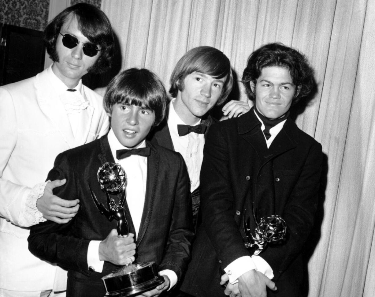 From left: Michael Nesmith, Davy Jones, Peter Tork and Mickey Dolenz of the Monkees pose with their Emmy Award for best comedy series in 1967 in Los Angeles. Nesmith died Friday at age 78.