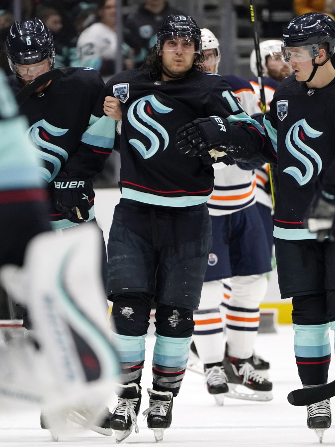 Seattle Kraken's Brandon Tanev is assisted off the ice after being injured against the Edmonton Oilers in the third period of an NHL hockey game Saturday, Dec. 18, 2021, in Seattle. The Oilers won 5-3.