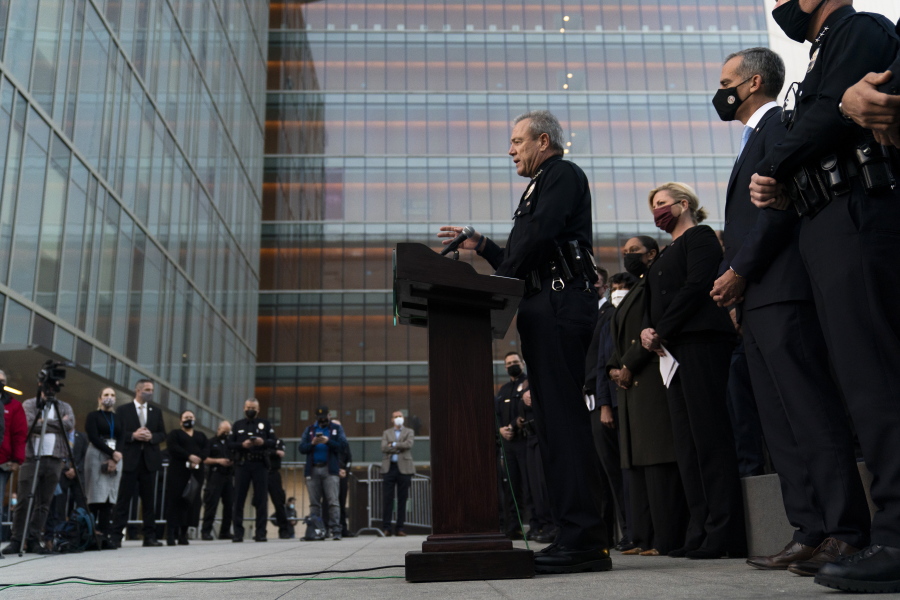 Los Angeles Police Chief Michel Moore, center, speaks during a news conference as he is joined by Mayor Eric Garcetti, second from right, outside the Los Angeles Police Headquarters Thursday, Dec. 2, 2021, in Los Angeles. Authorities in Los Angeles on Thursday announced arrests in recent smash-and-grab thefts at stores, part of a rash of organized retail crime in California. (AP Photo/Jae C.