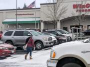A shopper heads into WinCo in east Vancouver on Sunday morning amid a dusting of snow.