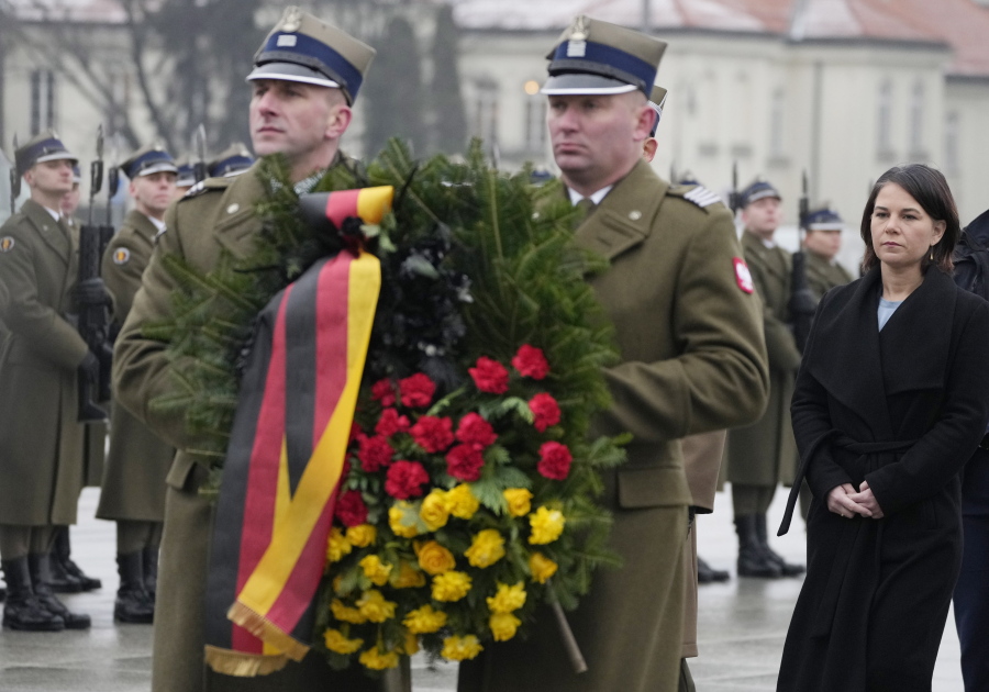 German Foreign Minister Annalena Baerbock attends a wreath-laying ceremony at the tomb of the Unknown Soldier in in Warsaw, Poland, Friday, Dec. 10, 2021.