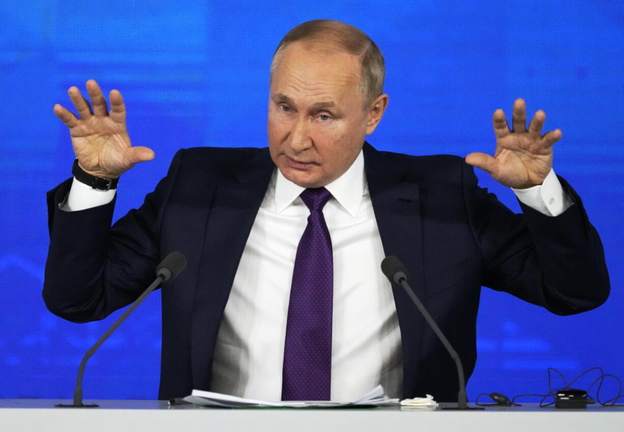 Russian President Vladimir Putin gestures while speaking during his annual news conference in Moscow, Russia, Thursday, Dec. 23, 2021.