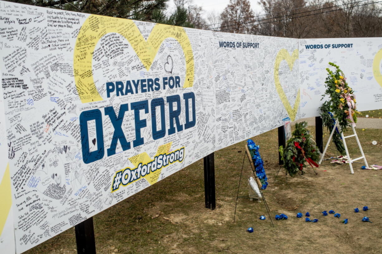 Handwritten messages are left at the memorial site at the memorial site on Tuesday, Dec. 7, 2021 outside Oxford High School in Oxford, Mich., after a 15-year-old allegedly killed these four classmates, and injured seven others in a shooting inside the northern Oakland County school one week earlier.