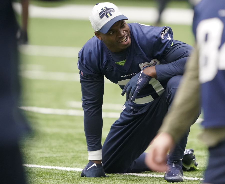 Running back Adrian Peterson, who was signed to the Seattle Seahawks practice squad on Wednesday, stretches Thursday, Dec. 2, 2021, before NFL football practice in Renton, Wash. (AP Photo/Ted S.