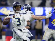 Seattle Seahawks quarterback Russell Wilson looks to throw during the first half of the team's NFL football game against the Los Angeles Rams on Tuesday, Dec. 21, 2021, in Inglewood, Calif.