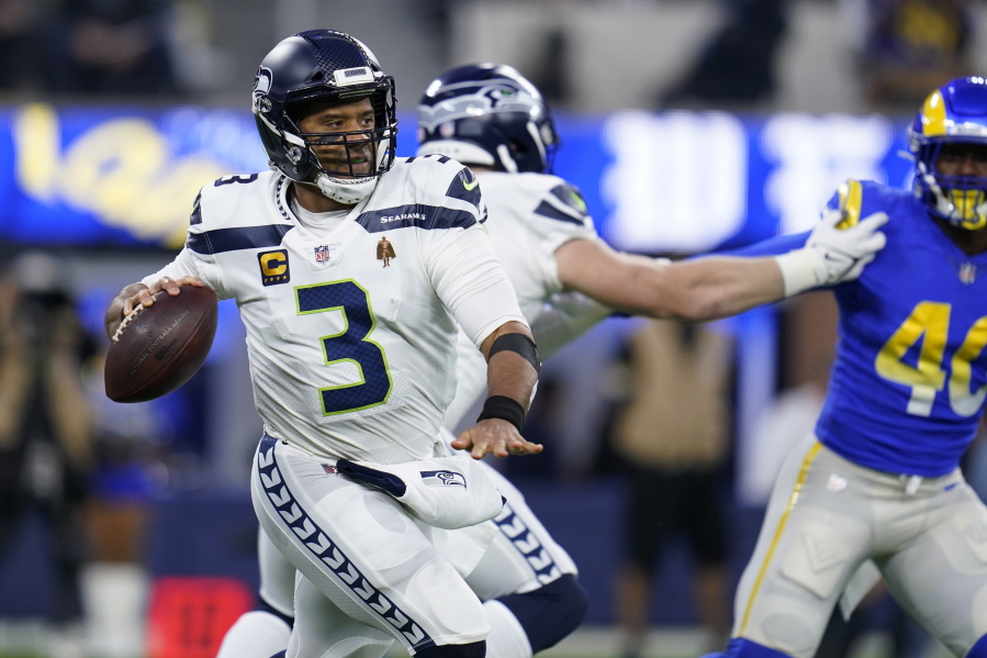 Seattle Seahawks quarterback Russell Wilson looks to throw during the first half of the team's NFL football game against the Los Angeles Rams on Tuesday, Dec. 21, 2021, in Inglewood, Calif.
