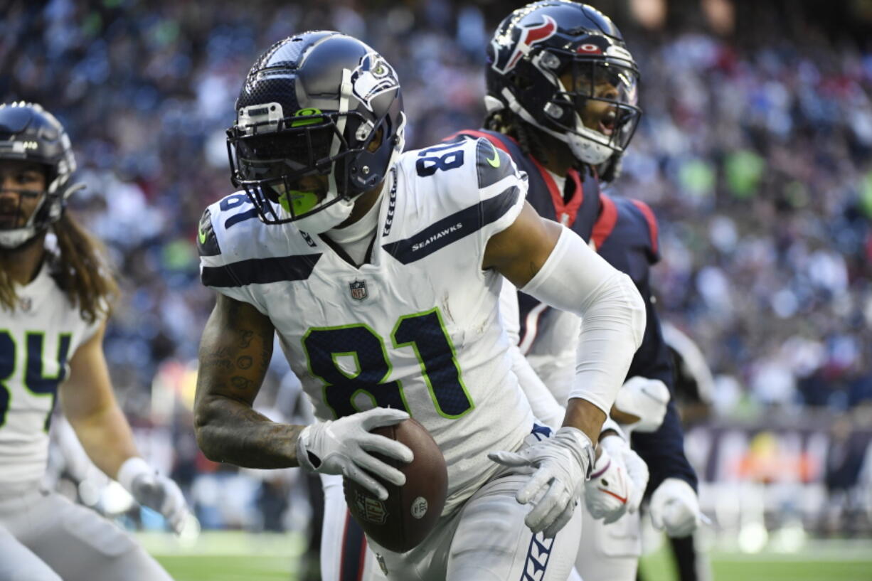 Seattle Seahawks tight end Gerald Everett (81) celebrates after scoring a touchdown against the Houston Texans during the second half of an NFL football game, Sunday, Dec. 12, 2021, in Houston.