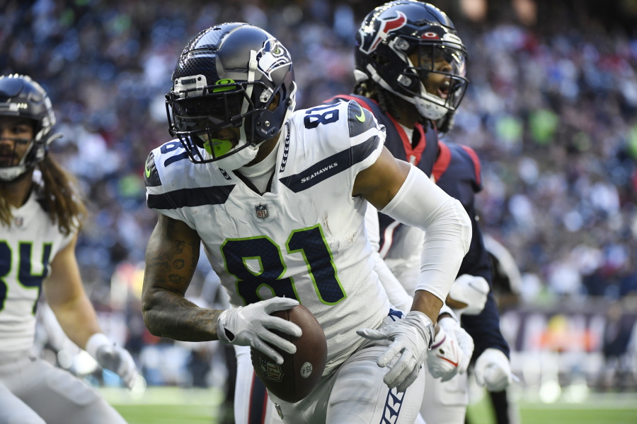 Seattle Seahawks tight end Gerald Everett (81) celebrates after scoring a touchdown against the Houston Texans during the second half of an NFL football game, Sunday, Dec. 12, 2021, in Houston.