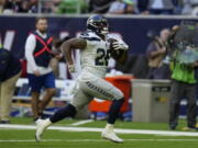 Seattle Seahawks running back Rashaad Penny (20) runs for a touchdown against the Houston Texans during the second half of an NFL football game, Sunday, Dec. 12, 2021, in Houston.