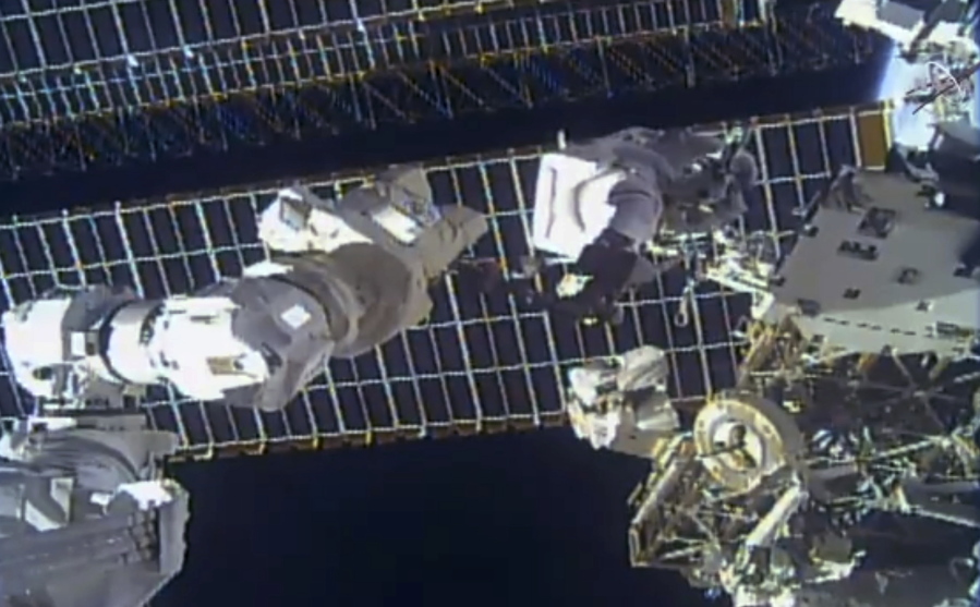 This photo provided by NASA shows astronaut Tom Marshburn replaces a broken antenna outside the International Space Station after getting NASA's all-clear for orbiting debris, on Thursday, Dec. 2, 2021.  Marshburn and Kayla Barron completed the job Thursday.