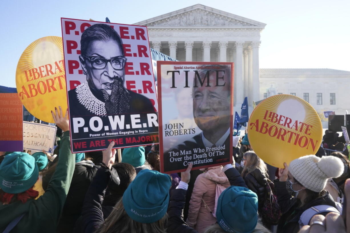 People demonstrate in front of the U.S. Supreme Court Wednesday, Dec. 1, 2021, in Washington, as the court hears arguments in a case from Mississippi, where a 2018 law would ban abortions after 15 weeks of pregnancy, well before viability.