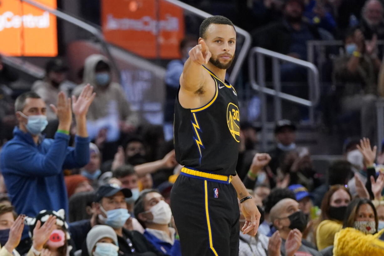 Golden State Warriors guard Stephen Curry gestures after shooting a 3-point basket against the Portland Trail Blazers during the first half of an NBA basketball game in San Francisco, Wednesday, Dec. 8, 2021.