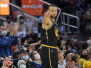 Golden State Warriors guard Stephen Curry gestures after shooting a 3-point basket against the Portland Trail Blazers during the first half of an NBA basketball game in San Francisco, Wednesday, Dec. 8, 2021.