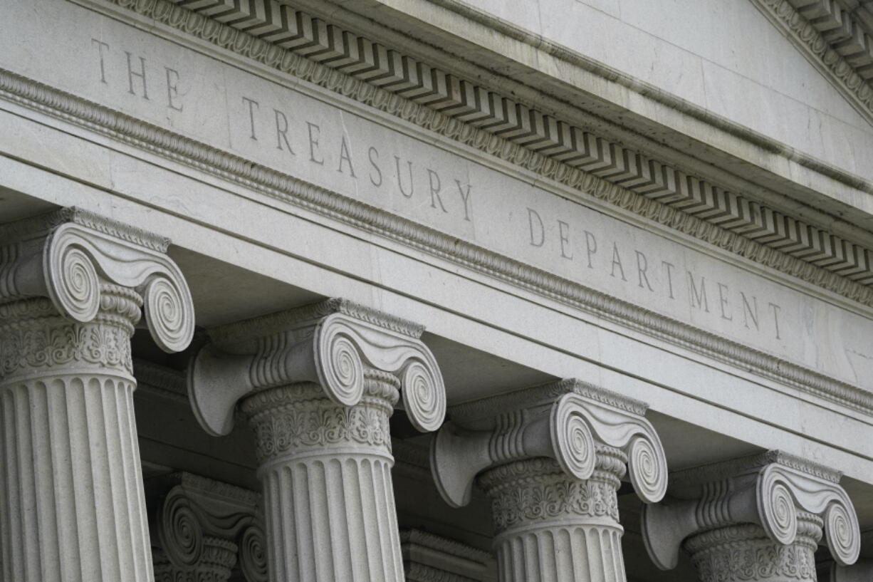 FILE - The Treasury Building is viewed in Washington, May 4, 2021.  In a report to Congress released Friday, Dec. 3, the Treasury Department cited China for a number of failing that are preventing its trading partners from gaining full knowledge of just how it is managing its currency.