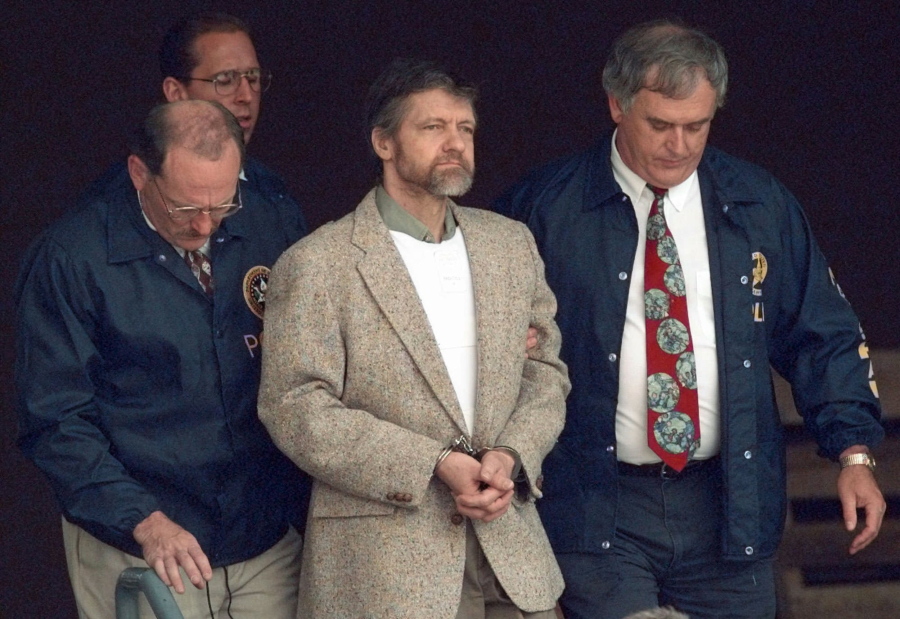 FILE - Theodore Kaczynski looks around as U.S. Marshals prepare to take him down the steps at the federal courthouse to a waiting vehicle on June 21, 1996, in Helena, Mont. The man known as the "Unabomber" has been transferred to a federal prison medical facility in North Carolina after spending the past two decades in a federal Supermax prison in Colorado for a series of bombings targeting scientists. A U.S. Bureau of Prisons inmate database shows seventy-nine-year-old Kaczynski has been moved to the bureau's Butner medical center in eastern North Carolina.