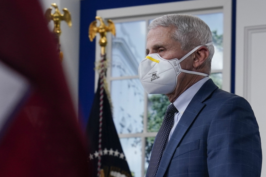 Dr. Anthony Fauci, the top U.S. infectious disease expert, wears a face mask as he arrives for the the White House COVID-19 Response Team's regular call with the National Governors Association in the South Court Auditorium in the Eisenhower Executive Office Building on the White House Campus, Monday, Dec. 27, 2021, in Washington. Fauci says the U.S. should consider a vaccination mandate for domestic air travel as coronavirus infections surge. To date the Biden administration has balked at the idea, anticipating legal entanglements.