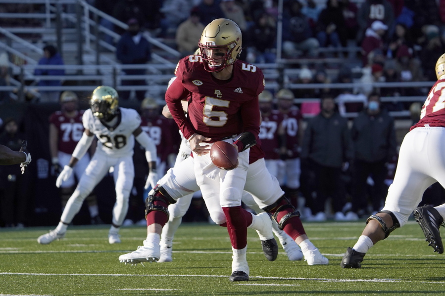 FILE - Boston College quarterback Phil Jurkovec (5) prepares to hand the ball off during the second half of an NCAA college football game against Wake Forest, Saturday, Nov. 27, 2021, in Boston. The Fenway Bowl and Military Bowl have been canceled due to the pandemic as coronavirus outbreaks at Virginia and Boston College forced them to call off their postseason plans.  The Military Bowl scheduled for Monday, Dec.