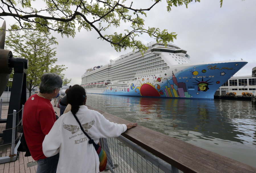 FILE - People pause to look at Norwegian Cruise Line's ship, Norwegian Breakaway, on the Hudson River, in New York, on May 8, 2013. Ten people aboard the cruise ship, approaching New Orleans, have tested positive for COVID-19, officials said Saturday night, Dec. 4, 2021. The Norwegian Breakaway had departed New Orleans on Nov. 28 and is due to return this weekend, the Louisiana Department of Health said in a news release. Over the past week, the ship made stops in Belize, Honduras and Mexico.