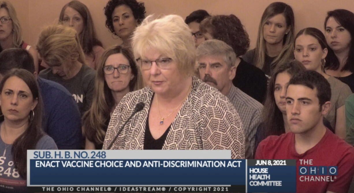 In this June 8, 2021, photo provided by the The Ohio Channel, Dr. Sherri Tenpenny speaks at a Ohio House Health Committee in Columbus, Ohio. The Cleveland-based osteopathic doctor testified that COVID-19 vaccines cause magnetism. "They can put a key on their forehead; it sticks," said Tenpenny.