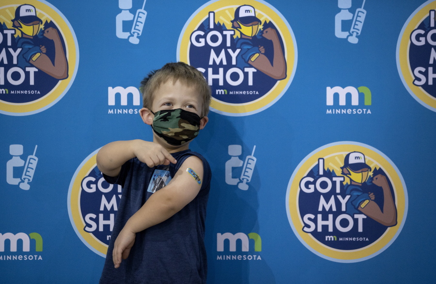 Zach Bakke, 8, of Minnetonka, Minn. poses for a photo on a selfie wall after getting a COVID-19 vaccine on Thursday, Dec. 2, 2021 at Mall of America in Bloomington, Minn.