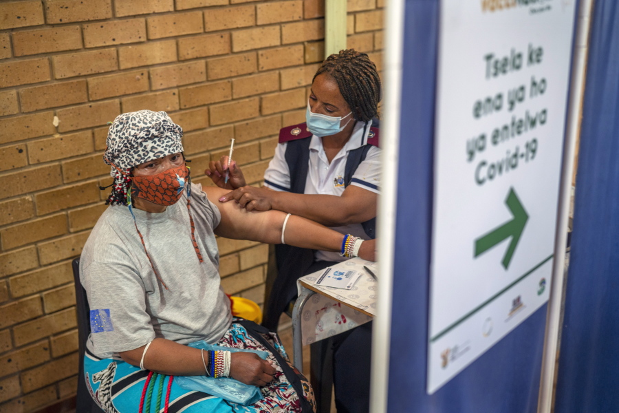 An Orange Farm, South Africa, resident receives her jab against COVID-19 Friday Dec. 3, 2021 at the Orange Farm multipurpose center. South Africa has accelerated its vaccination campaign a week after the discovery of the omicron variant of the coronavirus.