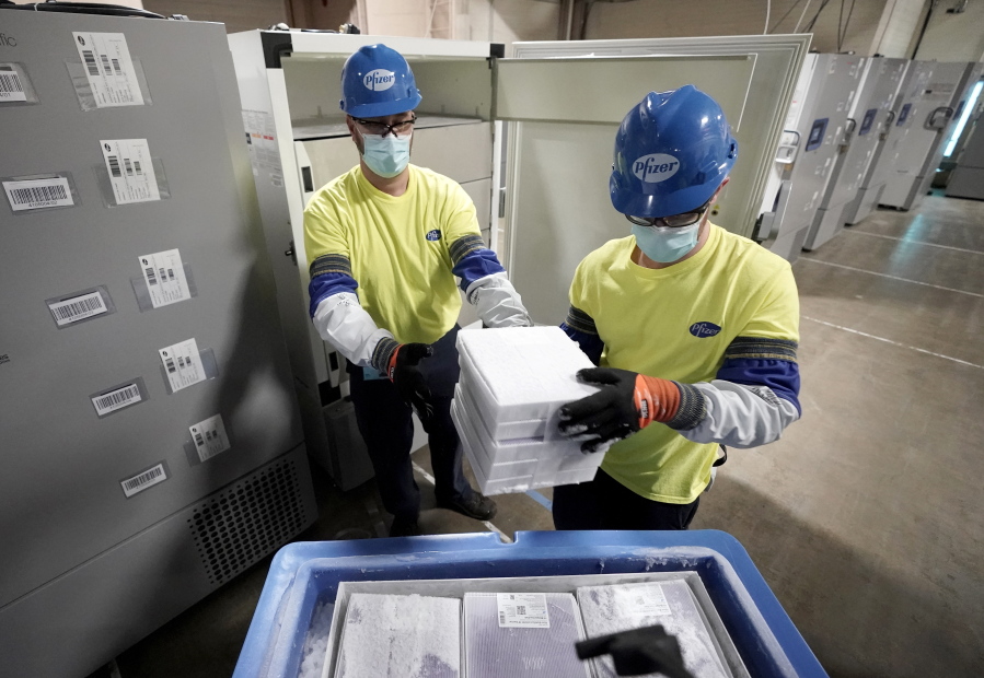 FILE - Boxes containing the Pfizer COVID-19 vaccine are prepared to be shipped at the Pfizer Global Supply Kalamazoo manufacturing plant in Portage, Mich., Dec. 13, 2020. The nation's COVID-19 death toll stands at around 800,000 as the anniversary of the U.S. vaccine rollout arrives. A year ago it stood at 300,000. What might have been a time to celebrate a scientific achievement is fraught with discord and mourning.