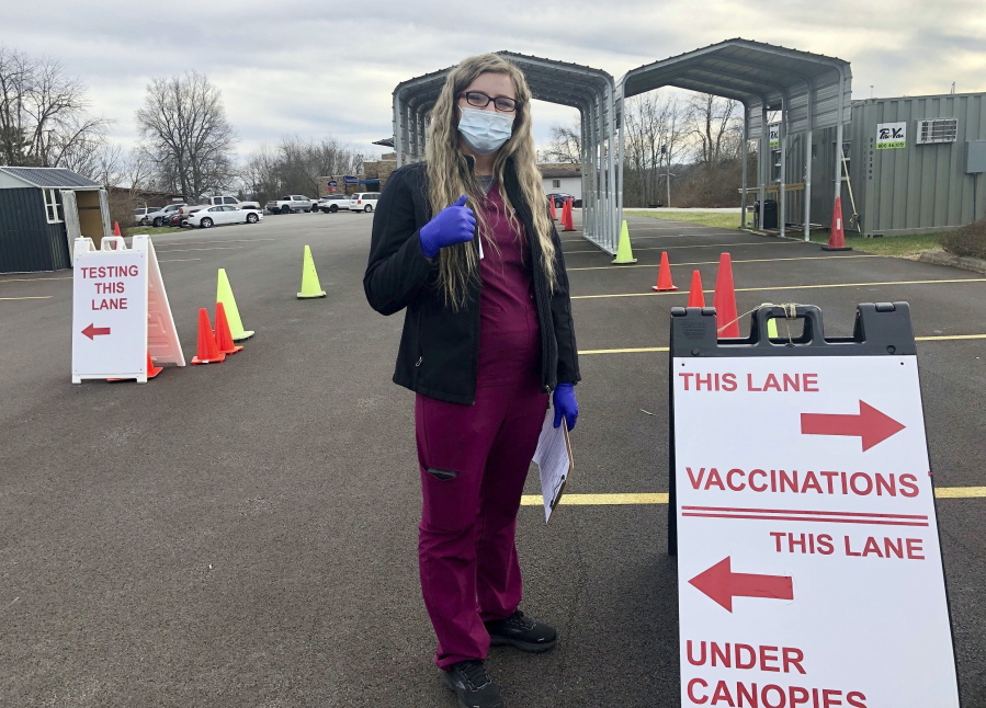 Roane General Hospital nurse Chania Batten is shown at a drive-thru COVID-19 vaccination clinic Tuesday, Dec. 21, 2021, in Spencer, W.Va. Batten says her job at times is overwhelming administering COVID-19 vaccines at the clinic at the only hospital in rural Roane County. She's spent months patiently answering questions, dispelling misinformation and reassuring the skeptical that the shots are the key to beating back the virus.