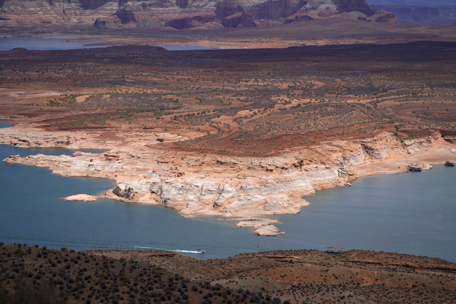 A boat moves along Wahweap Bay along the Upper Colorado River Basin, Wednesday, June 9, 2021, at the Utah and Arizona border near Wahweap, Ariz. Included in the infrastructure deal that became law last month is $2.5 billion for Native American water rights settlements, which quantify individual tribes' claims to water and identify infrastructure projects to help deliver it to residents. On the Navajo Nation, the largest reservation in the U.S., the money could fund a settlement reached in 2020 over water in the upper Colorado River basin.  (AP Photo/Ross D.