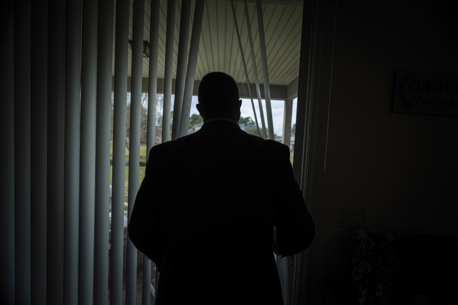Joseph Moore looks out of a window at his home in Jacksonville, Fla., on Tuesday, Dec. 7, 2021. Moore worked for nearly 10 years as an undercover informant for the FBI, infiltrating the Ku Klux Klan in Florida, foiling at least two murder plots, according to investigators, and investigating ties between law enforcement and the white supremacist organization. "From where I sat, with the intelligence laid out, I can tell you that none of these agencies have any control over any of it.