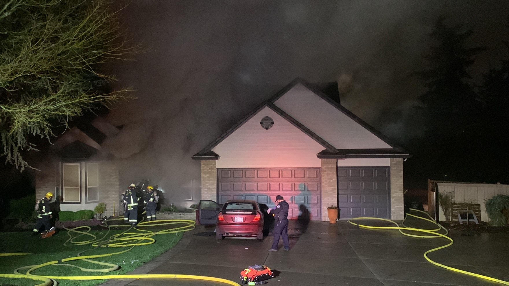 Crews from the Vancouver Fire Department battle a Saturday evening fire at a home in the 14600 block of Southeast 36th Circle in Vancouver's Columbia River neighborhood.