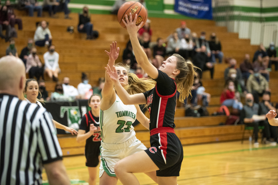 Camas junior Anna Mooney drives for a layup against Tumwater's Isabella Lund on Monday in Tumwater.